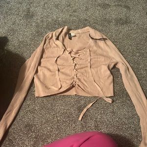 Beige crop top ties at front tight fitting. Size medium
